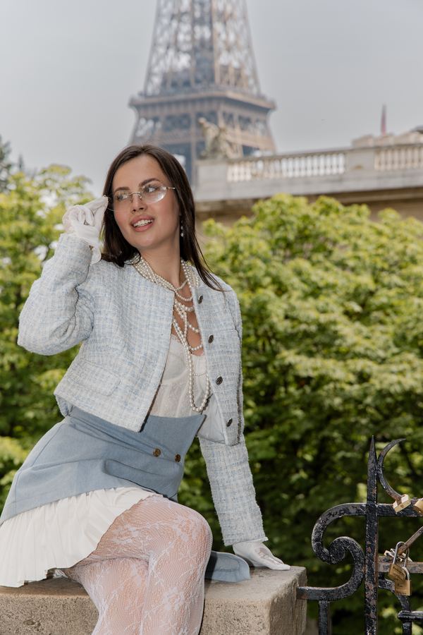 Portrait of a woman in blue tweed jacket, lace gloves, Trocadéro, Paris