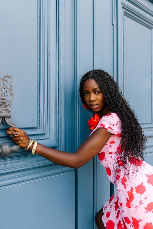 Portrait of a woman in red floral off-shoulder dress, Place Vendôme, Paris