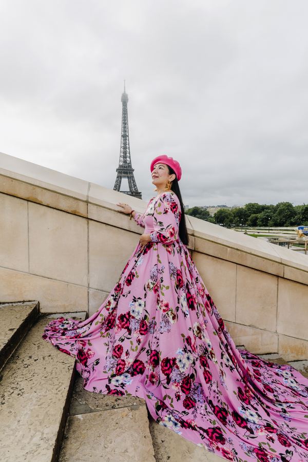 Portrait of a woman in pink floral long gown with train, pink beret, Trocadéro, Paris