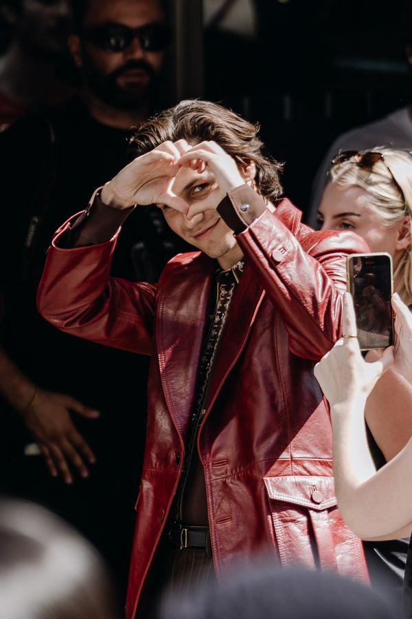 Street style at Paris Fashion Week: red leather coat, show venue entrance, Paris