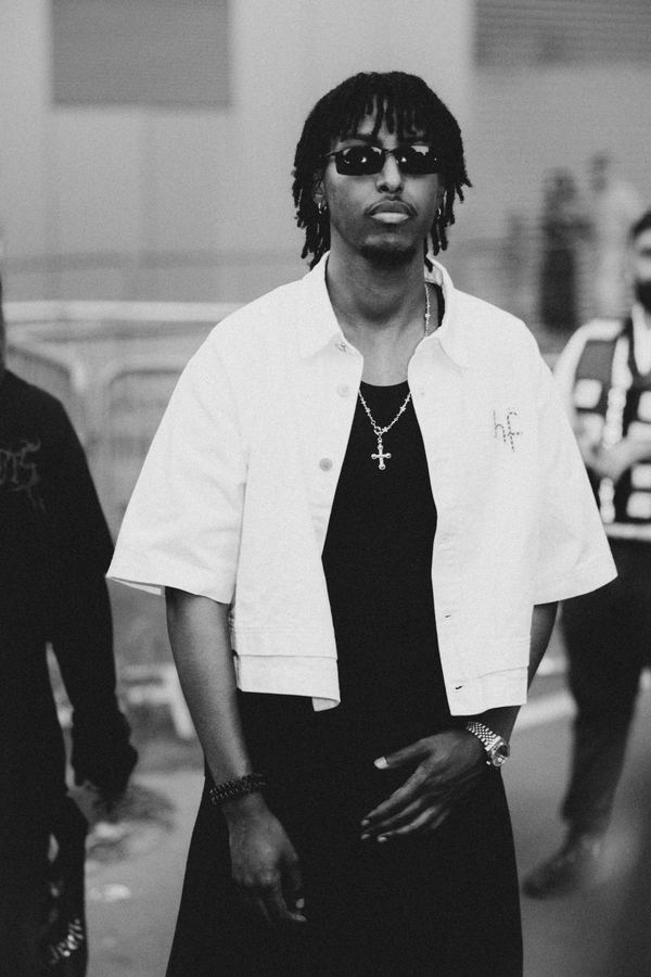 Street style at Paris Fashion Week: white cropped shirt, black tank, cross pendant, Paris
