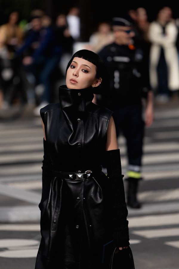 Street style at Paris Fashion Week: black leather sleeveless dress, high collar, Paris