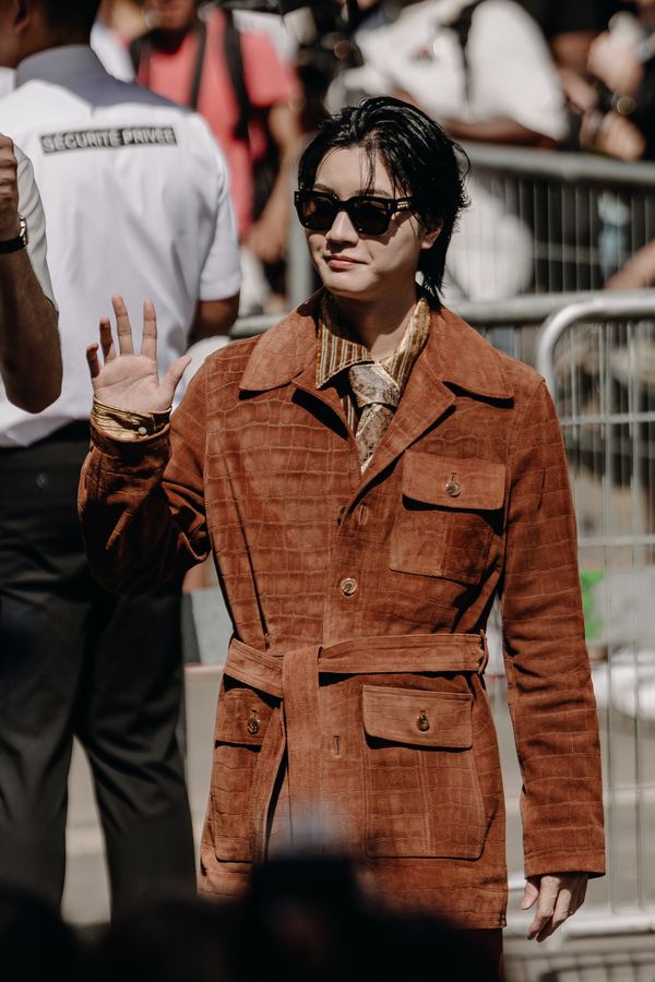 Street style at Paris Fashion Week: rust suede coat with belt, sunglasses, show venue entrance, Paris