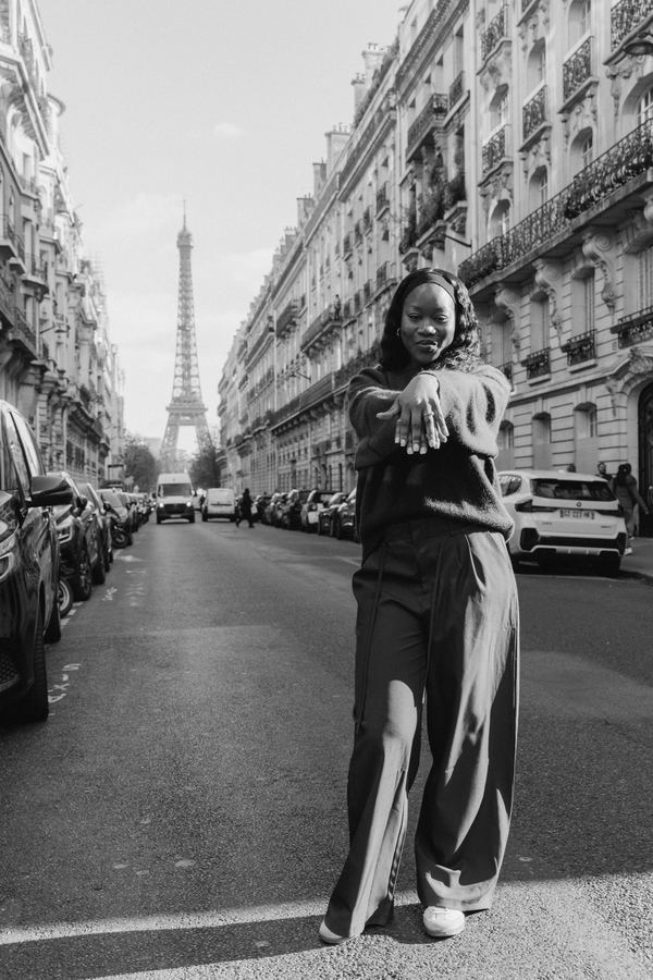 Portrait of a woman in brown knit sweater, brown wide-leg trousers, Paris