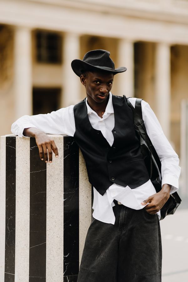 Portrait of a man in black vest, white shirt, black hat, dark trousers, Palais Royal, Paris