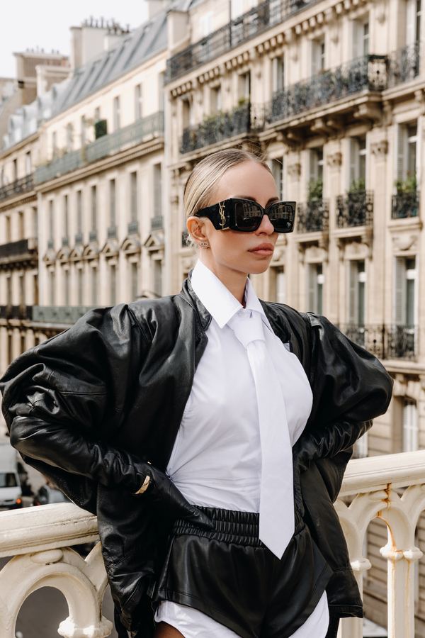Street style: black leather jacket, white shirt, tie, sunglasses, paris viaduct balustrade, Paris