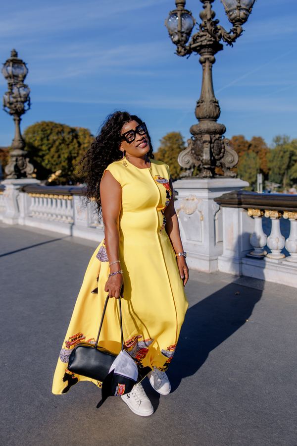 Portrait of a woman in yellow long dress, black handbag, Pont Alexandre III, Paris